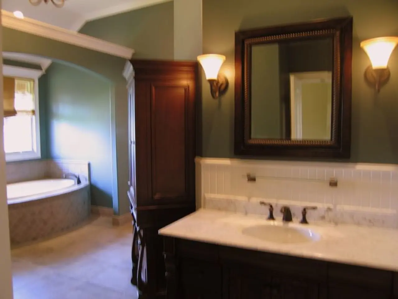 In this image I can see a wash basin, mirror, lights, door, bathtub, window and a wall. This image...