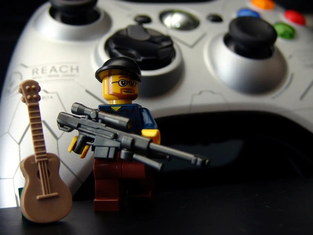 In the image there is a toy with gun and cap. Beside the toy there is a toy guitar. In the...