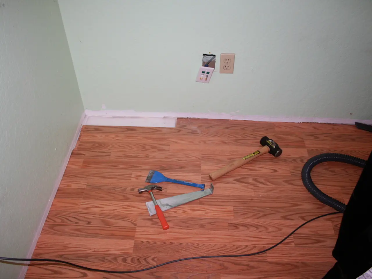 This is a picture of a room in this image at the bottom there is a wooden floor. On the floor there...