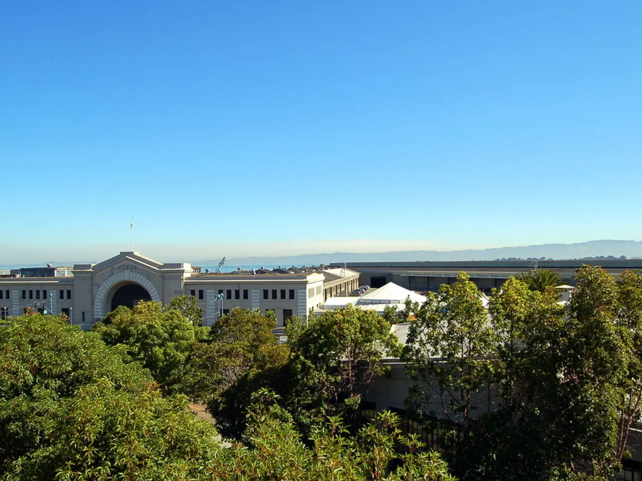In the image we can see there are buildings and there are lot of trees.