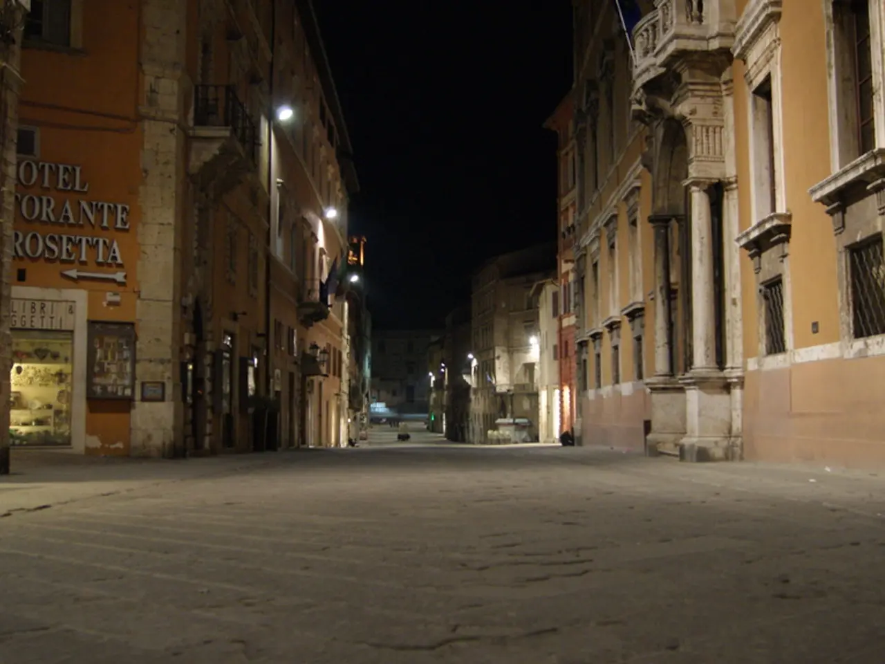 This image is clicked outside. There are buildings on the left side and right side. There are...