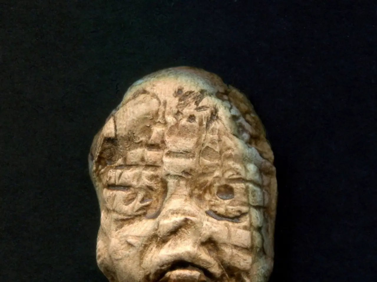 In this image we can see a sculpture made with stone.