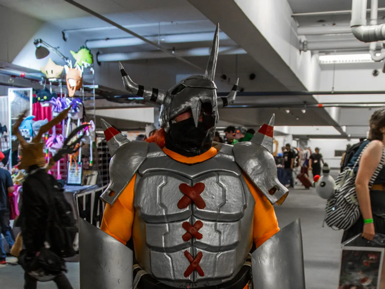 In the center of the image we can see a robot and there are people. In the background there is a...