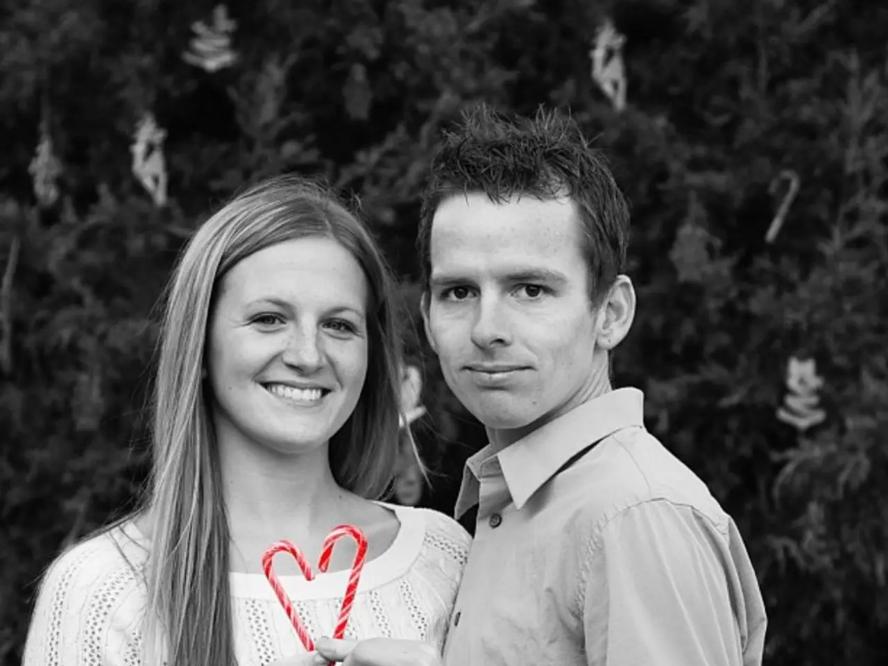 This image is taken outdoors. In the background there is a Christmas tree. In the middle of the...