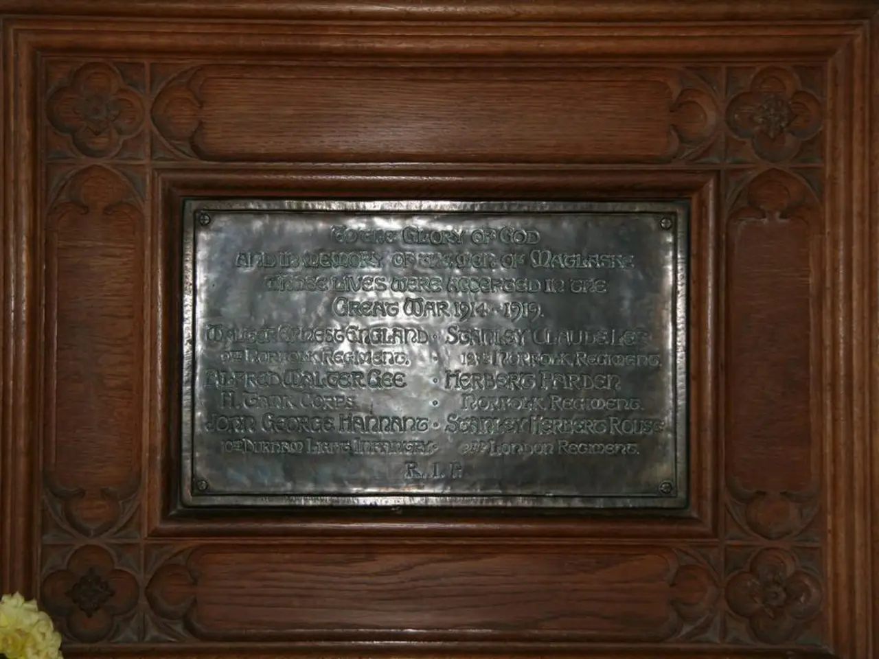 In this picture, we see a commemorative plaque with some text written on it. It is placed on the...