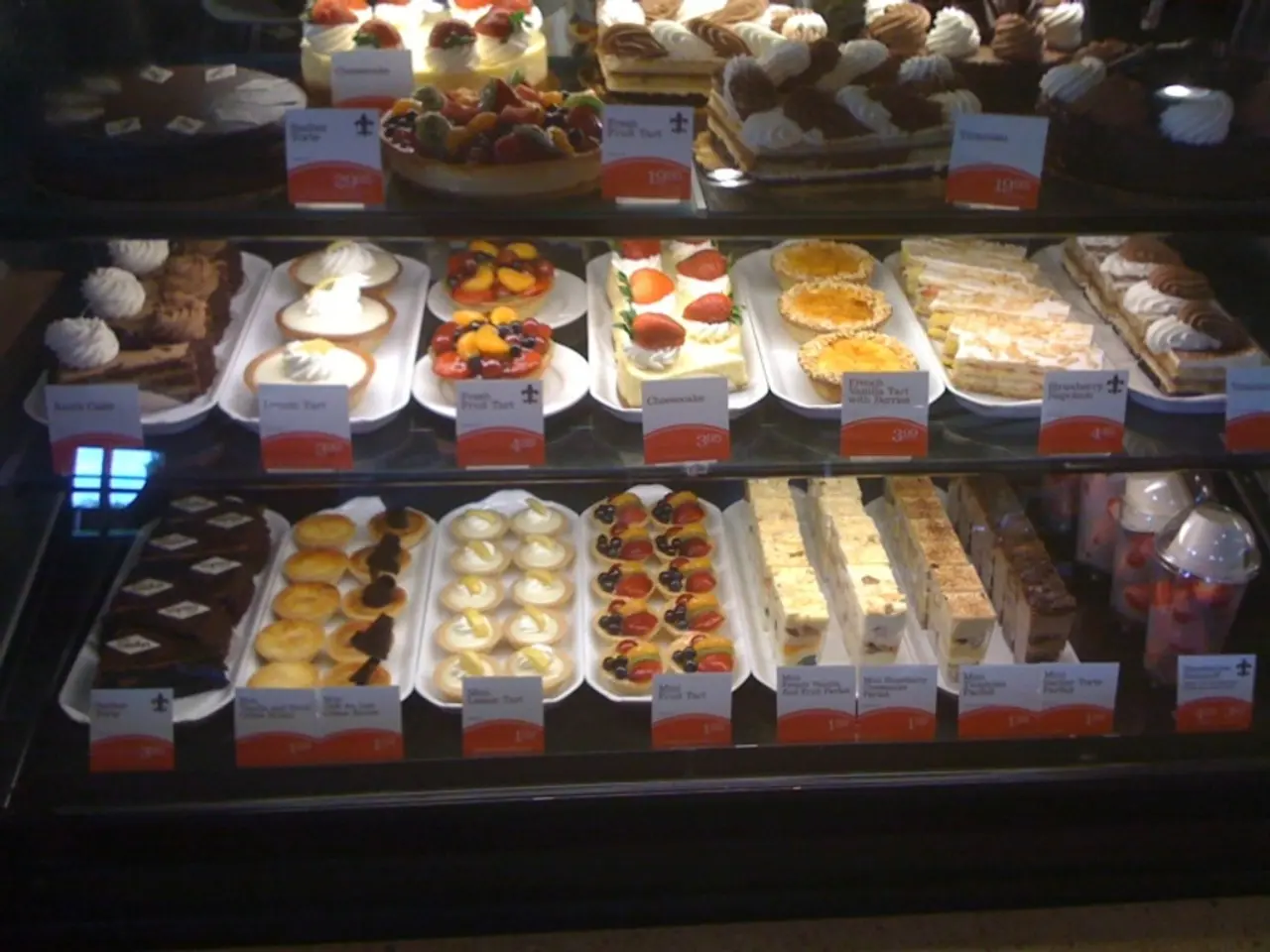 There are some cakes, baked food and some food items are kept and arranged in a rack as we can see...