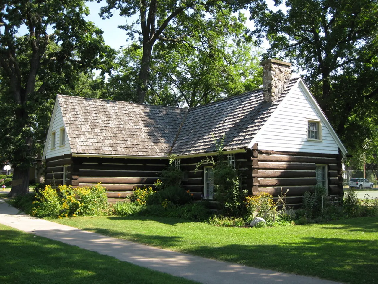 In this image I can see the house and the house is in brown and cream color. Background I can see...