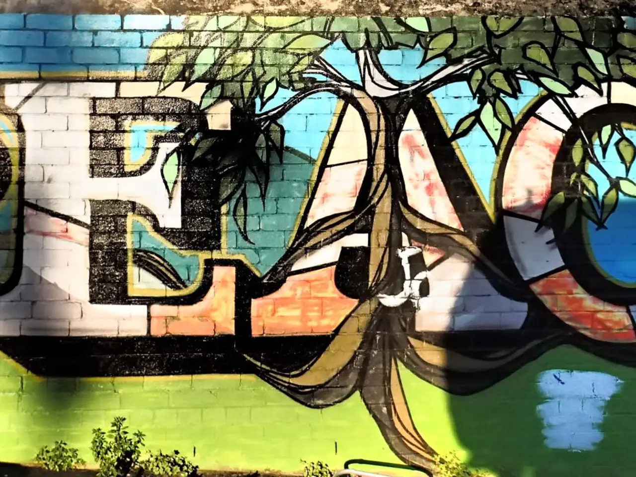 The image shows a mural on the side of a building with the word "peace" painted on it, surrounded...