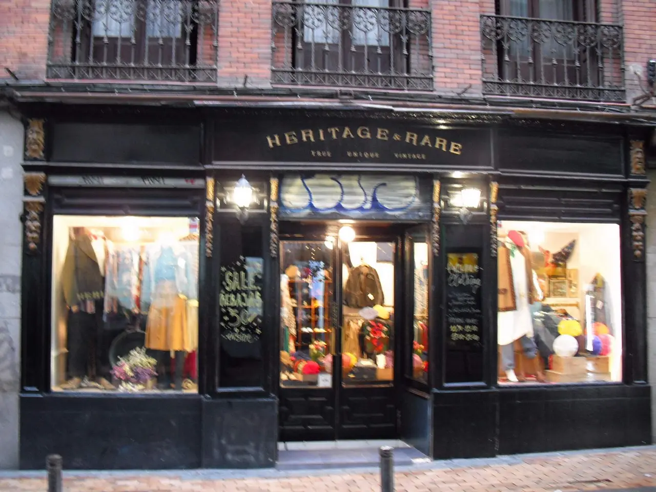 The image shows a heritage & rare boutique in Madrid, Spain. It is a building with windows,...