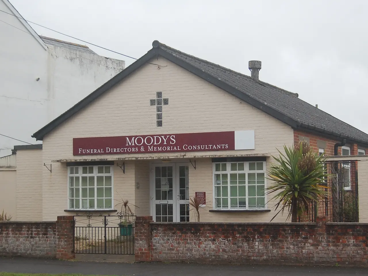The image shows Moody's Funeral Directors & Memorial Consultants, a house with windows and a door,...