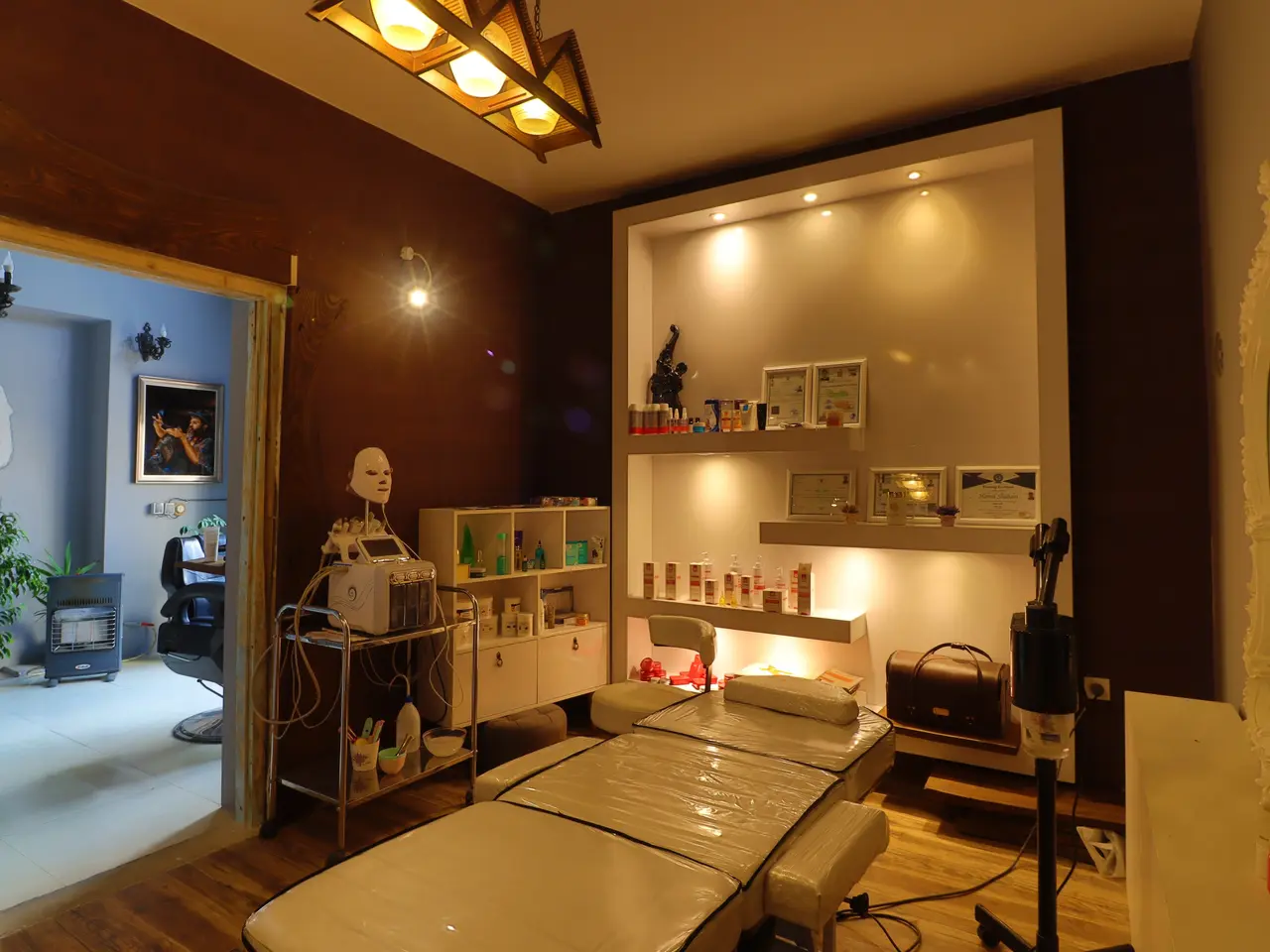 The image shows a room with a bed and a mirror on the wall, electric lights attached to the roof,...