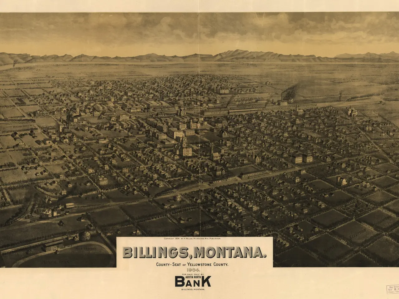 The image shows an aerial view of Billings, Montana, with buildings, trees, hills, and a sky in the...