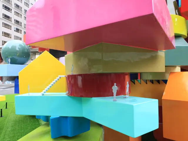 In the image we can see there are colourful blocks kept on the floor and behind there is a...