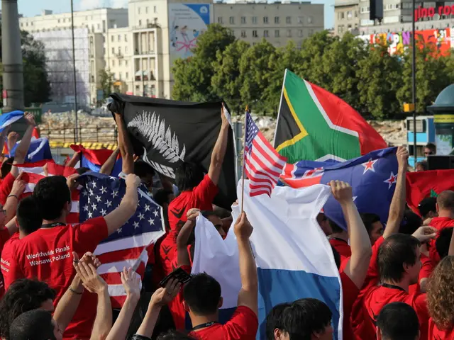 In this image there are so many group of people holding different flags, in front of them there are...