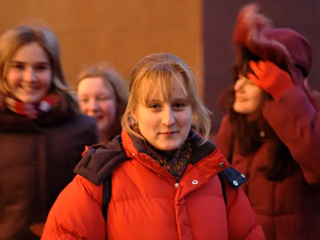 Here in this picture we can see a group of women standing over a place and all of them are wearing...