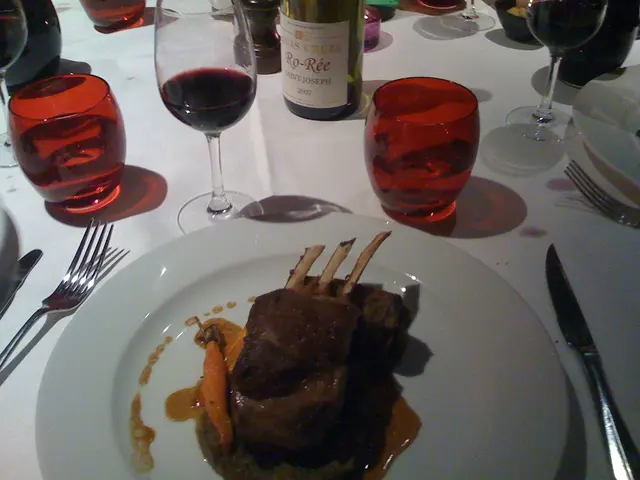 In this image we can see there is a table with food on the plate, behind that there are so many...