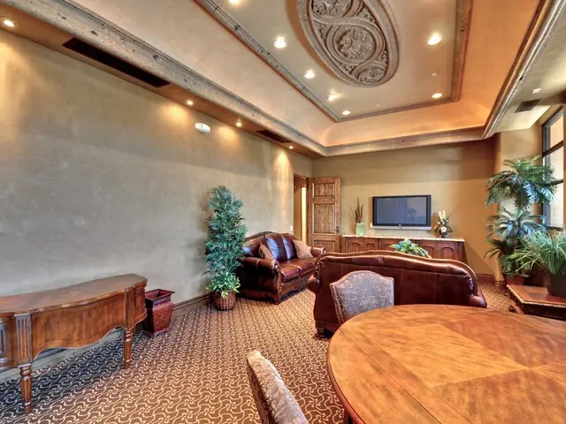 This image is clicked in a room. There are dining table, sofa, cushions, chairs in this image....
