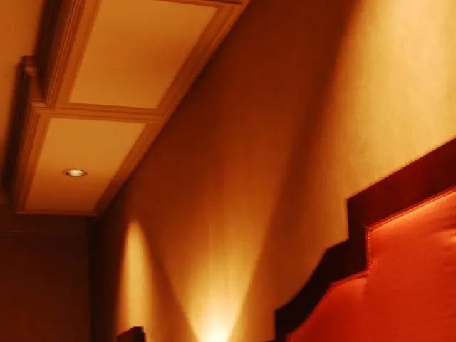 This picture describes about inside view of a room, in this we can find a bed, few pillows and...