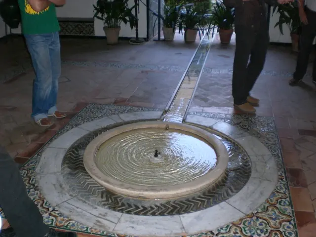 In this image we can see few people standing on the floor and there is a structure which looks like...