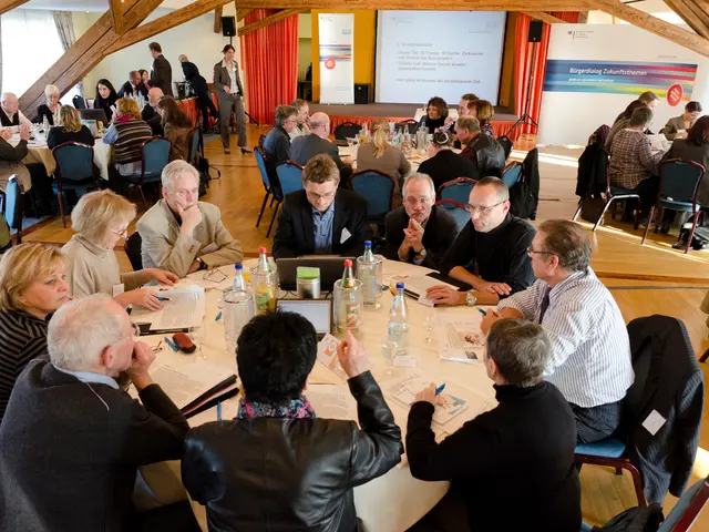 Here we can see a group of people are sitting on the chair, and in front here is the table laptops...