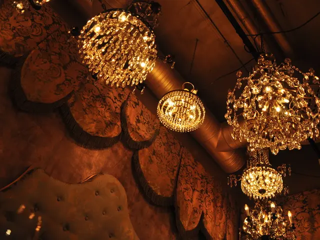 In this image we can see ceiling lights, wall, decorative items, pipe, and poles.