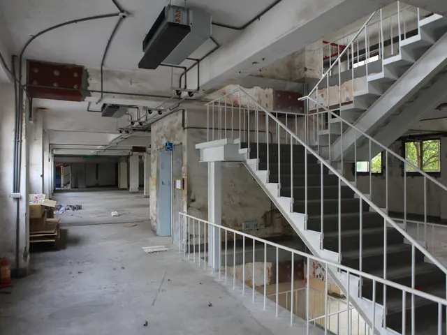 In this image we can see inside view of a building there are some pillars, doors, stairs, windows,...