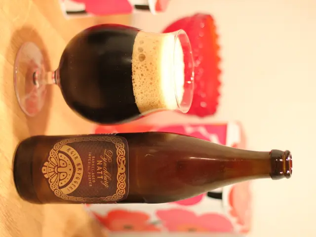 In this image we can see a wooden table where a wine bottle and a glass of wine are kept on it.