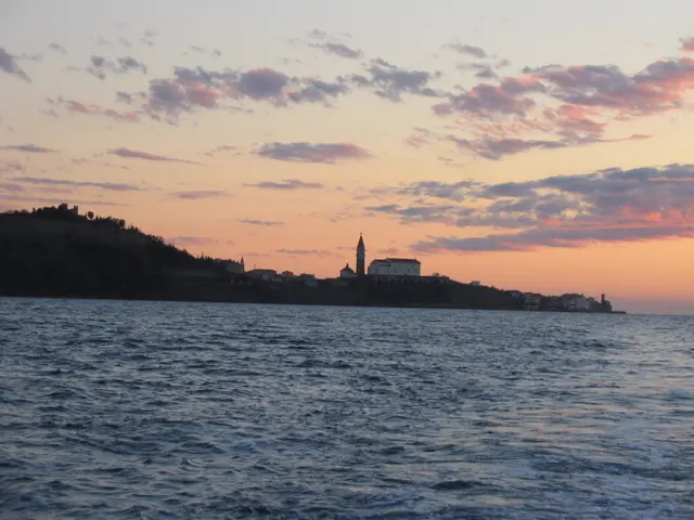 This picture is clicked outside the city. In the foreground we can see a water body. In the...