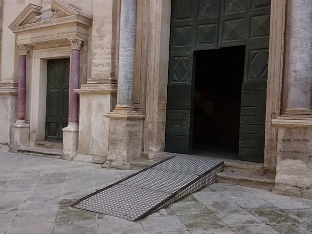 In this image I can see a building and a green colour door over there.