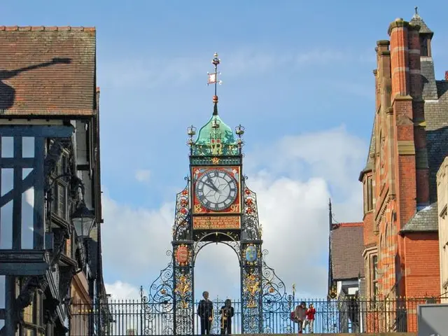 In this image there is a road in the middle. On the road there are so many people who are walking...