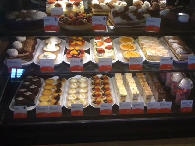 There are some cakes, baked food and some food items are kept and arranged in a rack as we can see...