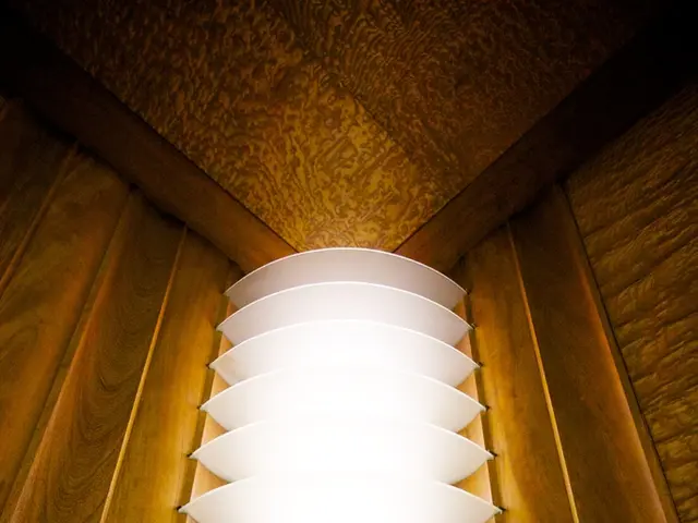 In this image we can see wooden wall and a decorative light.