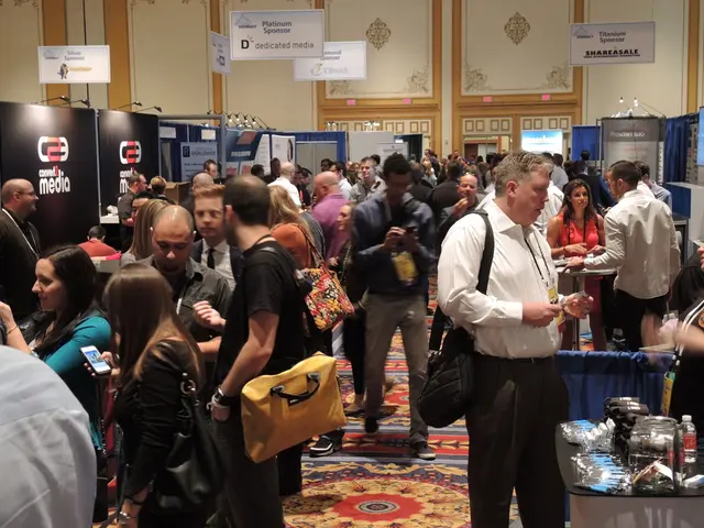 In this image i can see group of people standing at left a man wearing a yellow bag and a black...