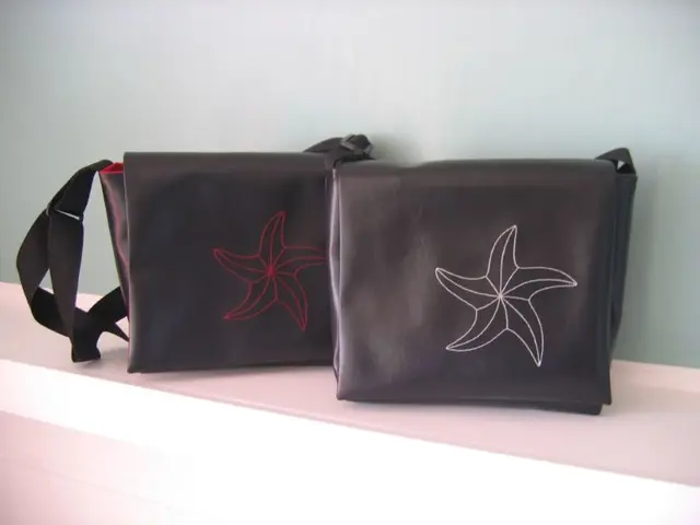 There are two hand bags in a shelf and the bags has a flower symbol on it.