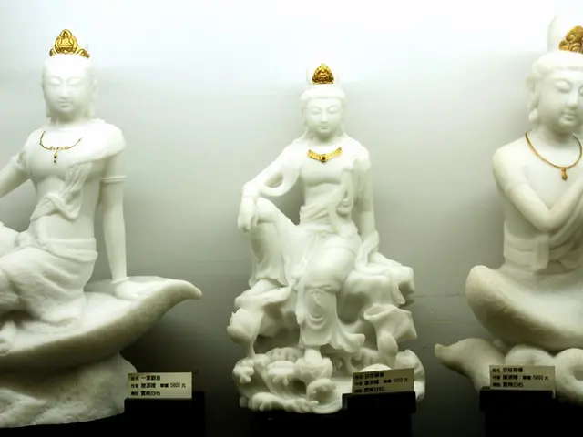 In the image we can see some idols. Behind the idols there is wall.