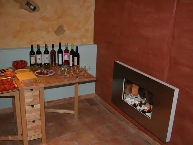 In this image I can see wine bottles, food items and some other objects on a wooden table. There...