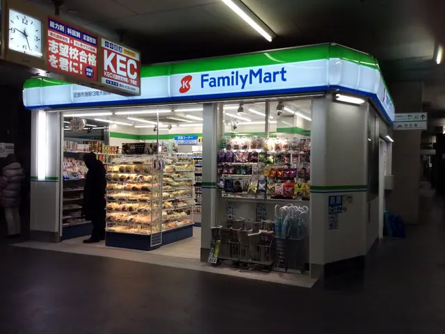 The image shows a family mart store in a subway station at night. There are a few people standing...