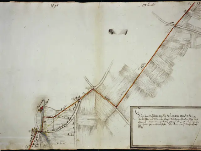 The image shows an open book with a drawing of a map on it. The map is detailed and shows the...