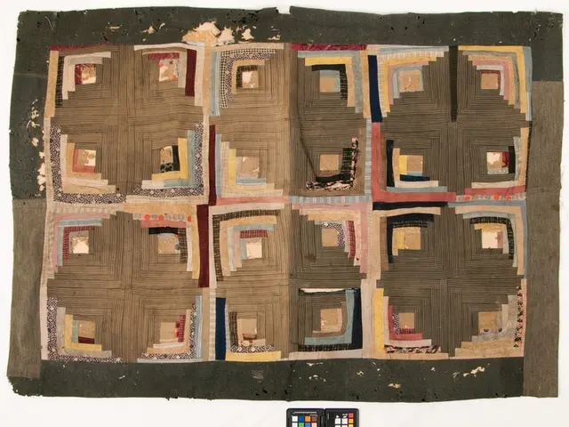 The image shows a piece of fabric with a pattern on it, featuring a variety of colors and shapes....