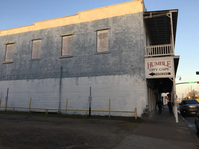 The image shows a building with a sign that reads "Humble City Cafe" on the side of it, surrounded...