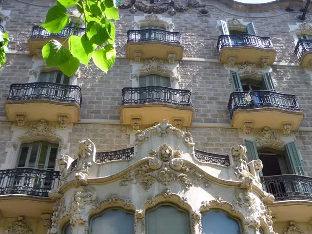 The image shows a building with many windows and balconies on the side of it, adorned with...