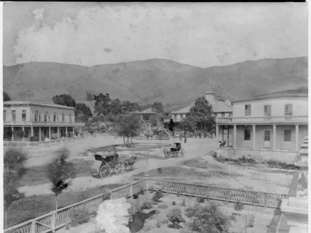 The image shows a black and white photo of the Warm Springs Hotel in Alameda, California. It...
