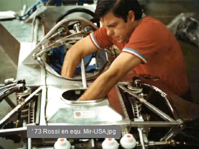 The image shows a man working on a car engine in a factory. He is surrounded by various machines...