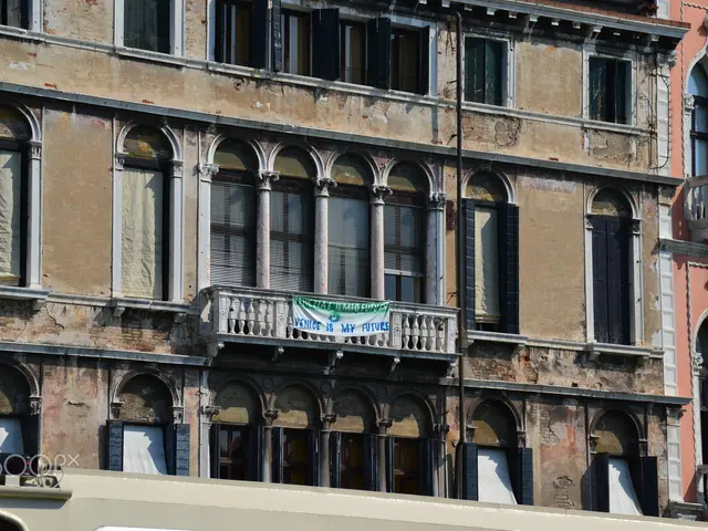 The image shows an old building with many windows and balconies in Venice, Italy. At the bottom of...