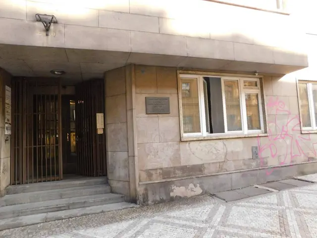 The image shows a building with graffiti on the side of it, located in Lisbon, Portugal. It has...