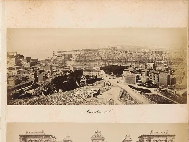 The image shows a black and white photo of a city with a fountain in the center, surrounded by...