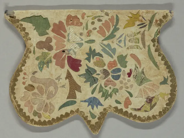 The image shows a fragment of a cloth with a painting of flowers and leaves on a white surface. The...