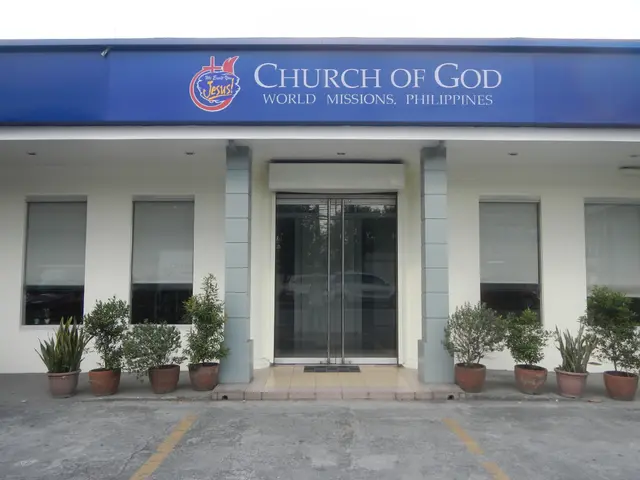 The image shows the Church of God in Manila, Philippines. It is a building with glass doors and...