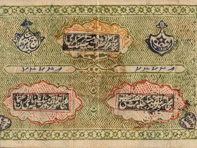The image shows an old banknote with Arabic writing on it against a black background. The text on...
