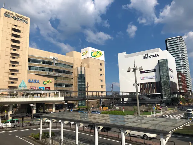 The image shows a bustling city street with tall buildings in the background, vehicles on the road,...